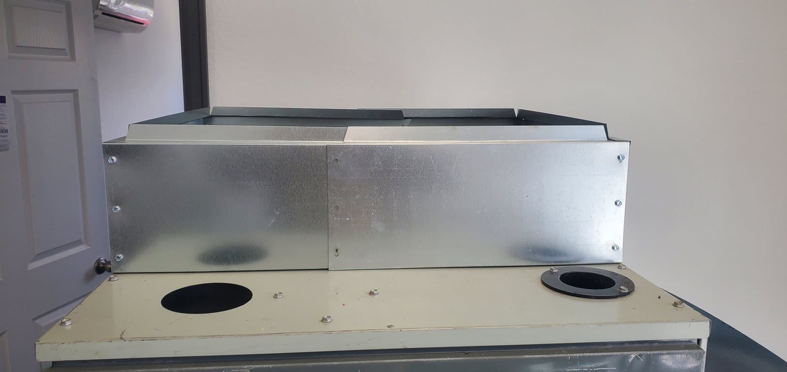 Coil transition mounted on a furnace cabinet with duct collars